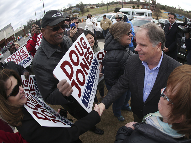 Democratic candidate for U.S. Senate Doug Jones greets supporters and voters outside Bethal Baptist Church on Tuesday, Dec. 12, 2017, in Birmingham, Ala. Jones is facing Republican Roy Moore. (AP Photo/John Bazemore)