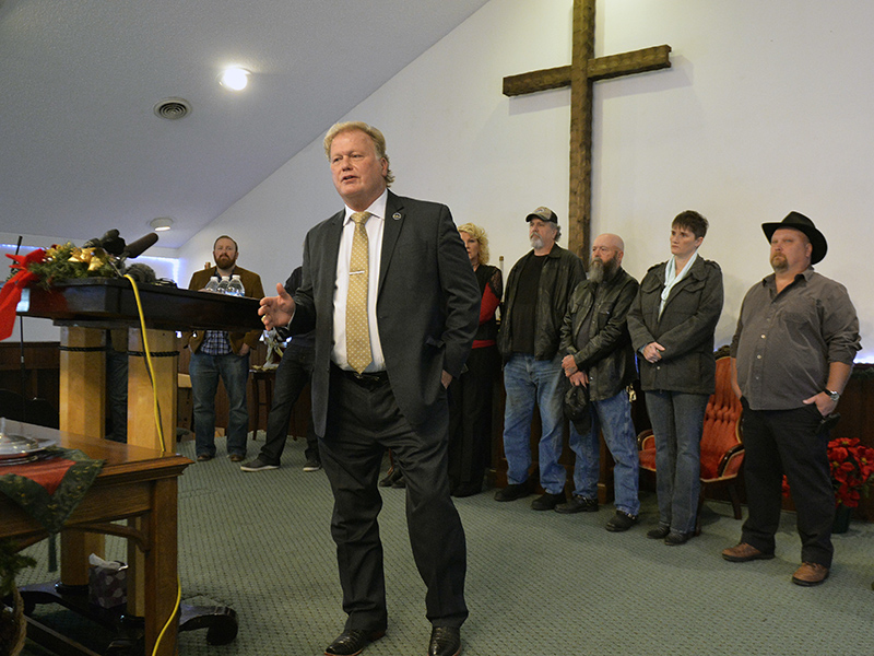With friends and family standing behind him, Kentucky state Rep. Dan Johnson addresses the public from his church on  Dec. 12, 2017, regarding allegations that he sexually abused a teenager after a New Year's party in 2013, in Louisville, Ky. Johnson said a woman's claim that he sexually assaulted her in 2013 has no merit and he will not resign. (AP Photo/Timothy D. Easley) (Caption amended by RNS)