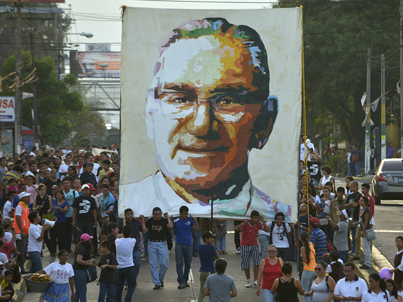 People carry a picture of the late Archbishop Oscar Arnulfo Romero on March 22, 2014, during a march ahead of the 34th anniversary of his assassination in San Salvador. For use only with RNS-ROMERO-POPE, transmitted on Feb. 3, 2015, Photo courtesy of Reuters/Jessica Orellana