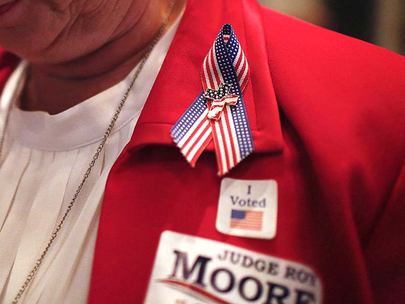 Barbra Nipper wears a cross in support of former Alabama Chief Justice and U.S. Senate candidate Roy Moore during Moore's campaign party Aug. 15, 2017, in Montgomery, Ala. (AP Photo/Brynn Anderson)