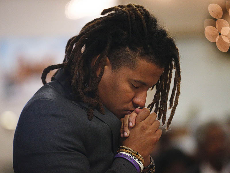 Jeremiah Chapman, prays during a 16th Street Baptist church service, Sunday, Dec. 10, 2017, in Birmingham, Ala. At the church pastor Arthur Price told the mostly black congregation that Alabama's U.S. Senate election is too important to skip. "There's too much at stake for us to stay home," Price said of Tuesday's election. (AP Photo/Brynn Anderson)