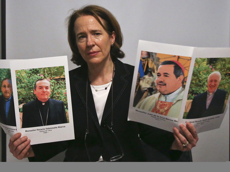 Anne Barrett Doyle, co-director of BishopAccountability.org, a U.S.-based group that has compiled a clergy abuse database, shows images of Catholic clerics implicated in abuse cases against children and teens, during a news conference in Santiago, Chile, on Jan. 10, 2018. The Vatican was planning to ask three Chilean bishops to resign  and take a year's sabbatical after they were accused of knowing about sexual abuse by Chile's most notorious pedophile, according to a confidential 2015 letter from Pope Francis to Chile's bishops. But the plan went awry after word got out. (AP Photo/Esteban Felix) (Caption amended by RNS)