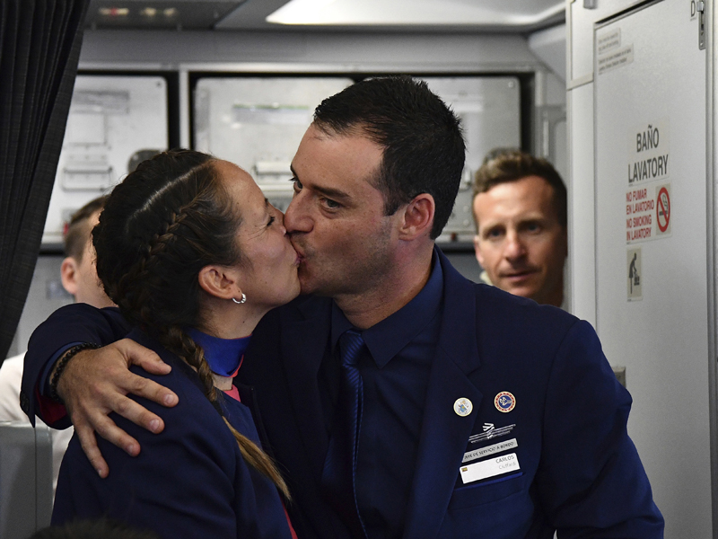 Crew members Paula Podest and Carlos Ciuffardi kiss before journalists after being married by Pope Francis during the flight between Santiago and the northern city of Iquique, Chile, Thursday, Jan. 18, 2018. Francis celebrated the first-ever airborne papal wedding, marrying these two flight attendants from Chile's flagship airline during the flight. The couple had been married civilly in 2010; however, they said they couldn't follow up with a church ceremony because of the 2010 earthquake that hit Chile. (Vincenzo Pinto, POOL via AP; caption amended by RNS)