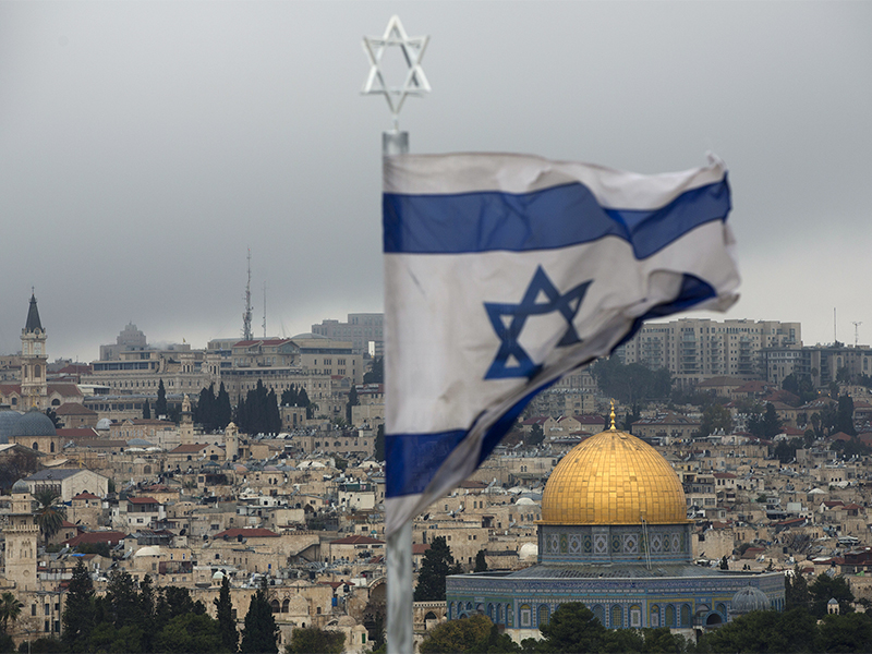 A view of the Dome of the Rock and Jerusalem’s Old City, behind an Israeli flag, seen from the Mount of Olives on Dec. 6, 2017. (AP Photo/Oded Balilty)