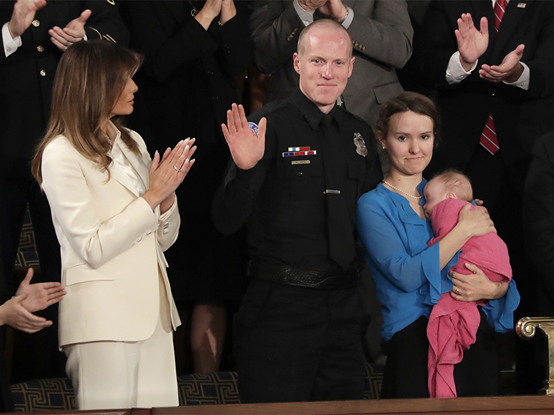 Albuquerque, N.M., Police Officer Ryan Holets and his wife, Rebecca, holding adopted daughter Hope, acknowledge their introduction by President Trump as they stand with first lady Melania Trump during the State of the Union address to a joint session of Congress on Capitol Hill in Washington on Jan. 30, 2018. (AP Photo/J. Scott Applewhite; caption amended by RNS)