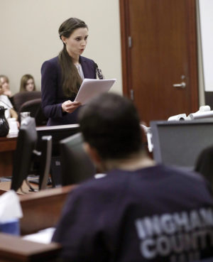 Former gymnast Rachael Denhollander gives her victim impact statement during the seventh day of Larry Nassar's sentencing hearing Wednesday, Jan. 24, 2018, in Lansing, Mich. Nassar has admitted sexually assaulting athletes when he was employed by Michigan State University and USA Gymnastics, which is the sport's national governing organization and trains Olympians. (AP Photo/Carlos Osorio)