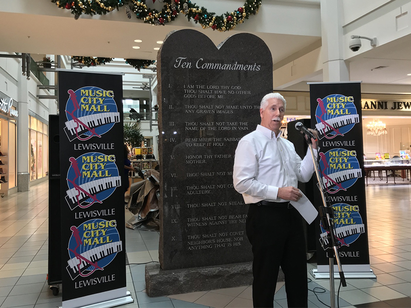 Music City Mall Lewisville general manager Richard Morton unveils a stone tablet that displays the Ten Commandments on Dec. 29, 2017, in Lewisville, Texas. Photo courtesy of Music City Mall Lewisville