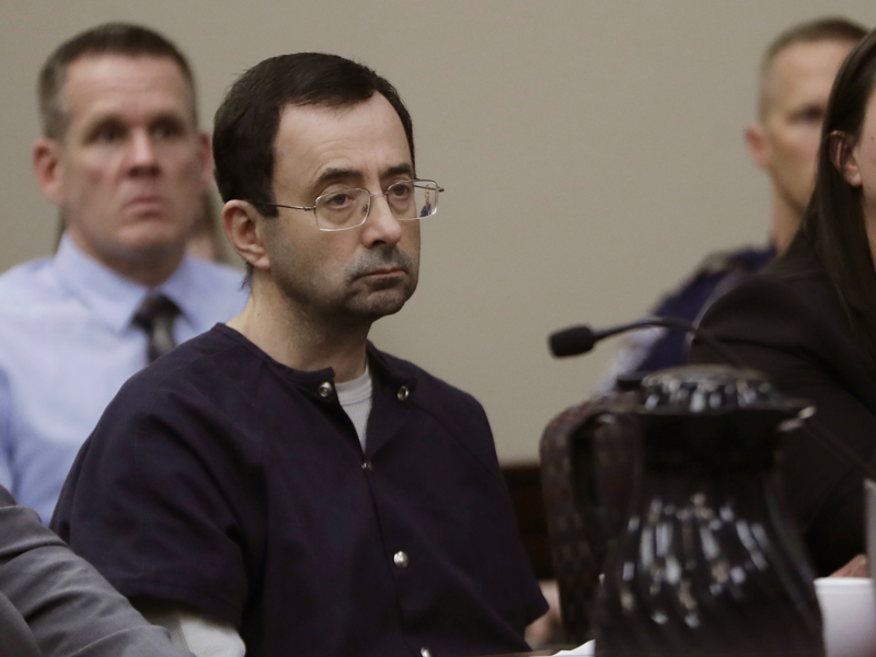 Larry Nassar sits during his sentencing hearing Jan. 24, 2018, in Lansing, Mich. The former sports doctor who admitted molesting some of the nation's top gymnasts for years was sentenced to 40 to 175 years in prison as the judge declared: "I just signed your death warrant." The sentence capped a remarkable seven-day hearing in which scores of Nassar's victims were able to confront him in the Michigan courtroom. (AP Photo/Carlos Osorio)
