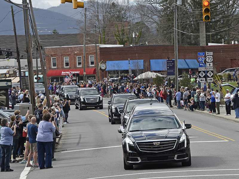 People line the street to pay respects as the hearse carrying the body of the Rev. Billy Graham travels through Black Mountain, N.C., on Feb. 24, 2018. The procession is part of more than a week of mourning that culminates with his burial next week at his library in Charlotte. (AP Photo/Kathy Kmonicek, Pool)