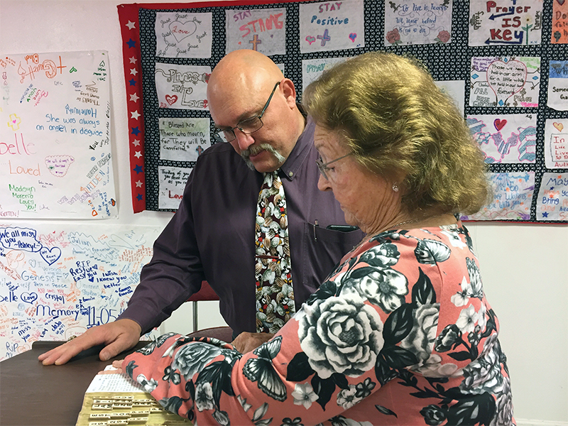 Pastor Frank Pomeroy discusses a Bible passage with church member Mary Dykeman at First Baptist Church in Sutherland Springs. RNS photo by Yonat Shimron