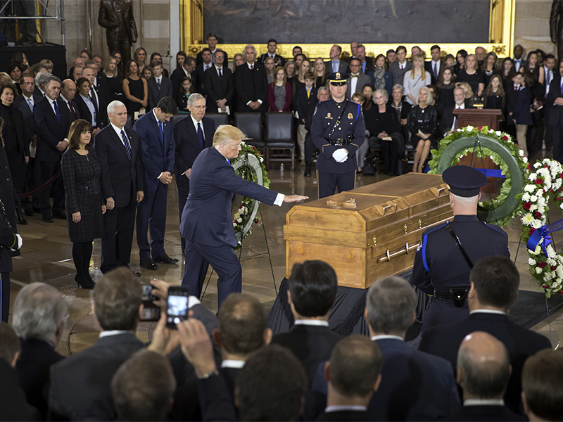 President Trump touches the casket of Billy Graham during a ceremony Feb. 28, 2018, in the U.S. Capitol Rotunda in Washington. Graham, who died last week at age 99, will lie in honor as a tribute to America's most famous evangelist. Trump was joined, from left to right behind him, by Karen Pence, Vice President Mike Pence, Speaker of the House Paul Ryan and Senate Majority Leader Mitch McConnell. (AP Photo/J. Scott Applewhite)