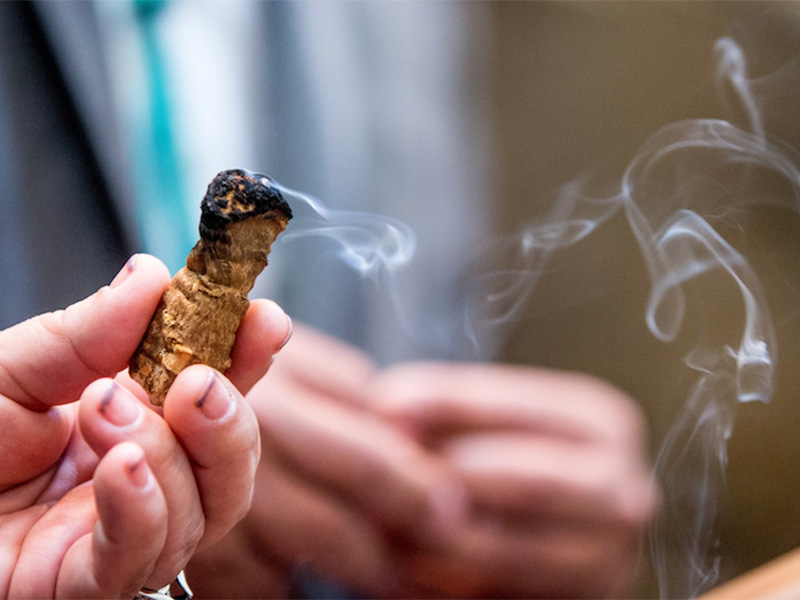 Hoopa Valley Tribal Council member Leilani Pole burns incense and says a prayer as a group of American Indian Nations and American Indian advocates hold a news conference at the Smithsonian National Museum of the American Indian in Washington on May 24, 2016. (AP Photo/Andrew Harnik; caption amended by RNS)