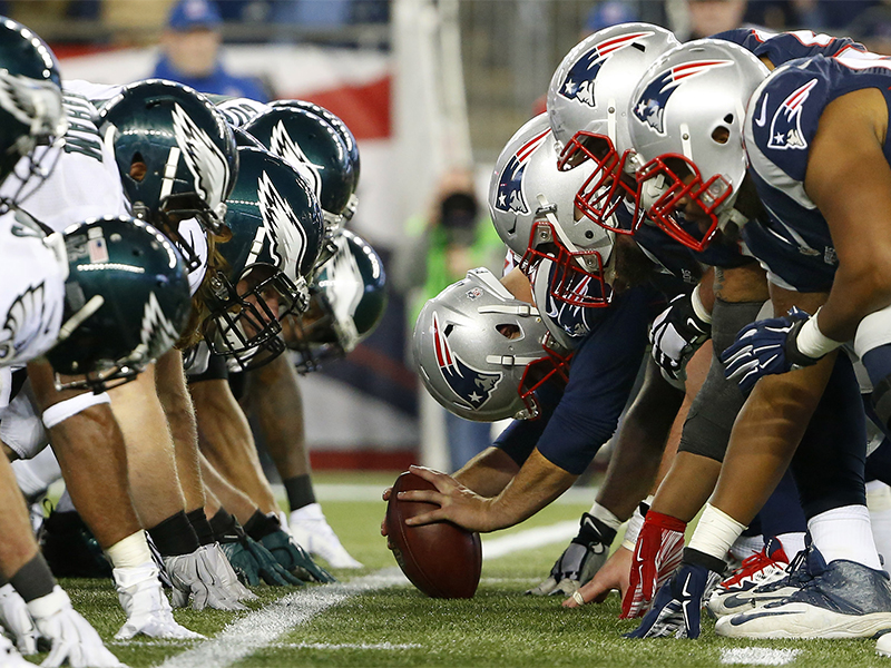 The New England Patriots and the Philadelphia Eagles at the line of scrimmage for the snap during an NFL football game at Gillette Stadium in Foxborough, Mass., on Dec. 6, 2015. (Winslow Townson/AP Images for Panini; caption amended by RNS)