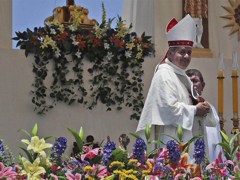 Osorno Bishop Juan Barros smiles as he leaves the altar after Mass was celebrated by Pope Francis on Lobito Beach in Iquique, Chile, Thursday, Jan. 18, 2018. The Vatican said Tuesday, Jan. 30, 2018 that Maltese Bishop Charles Scicluna, the Vatican's most respected sex crimes expert, would travel to Chile 