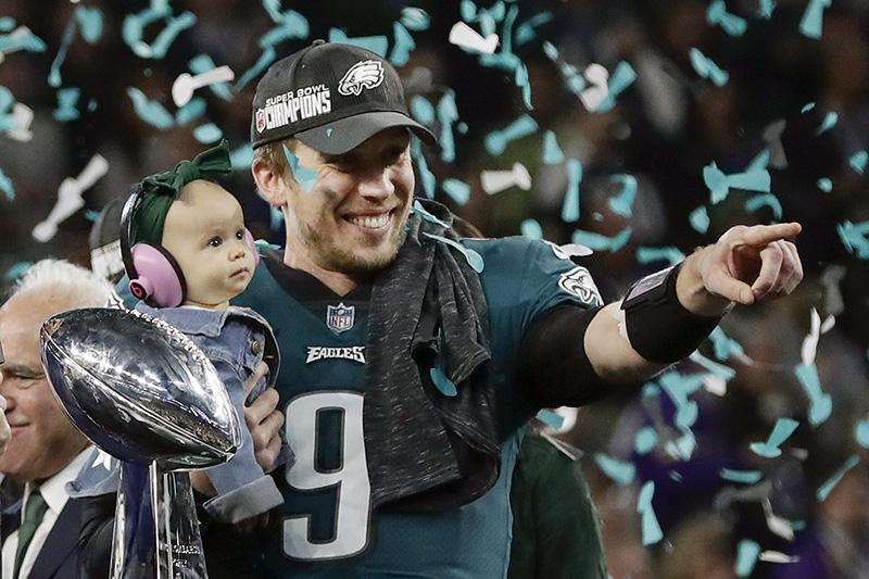Philadelphia Eagles quarterback Nick Foles holds his daughter, Lily, after beating the New England Patriots in the NFL Super Bowl 52 football game Sunday, Feb. 4, 2018, in Minneapolis. Foles, who was named the Super Bowl MVP, is currently an online graduate student at Liberty University, earning his master's degree in divinity. (AP Photo/Frank Franklin II)