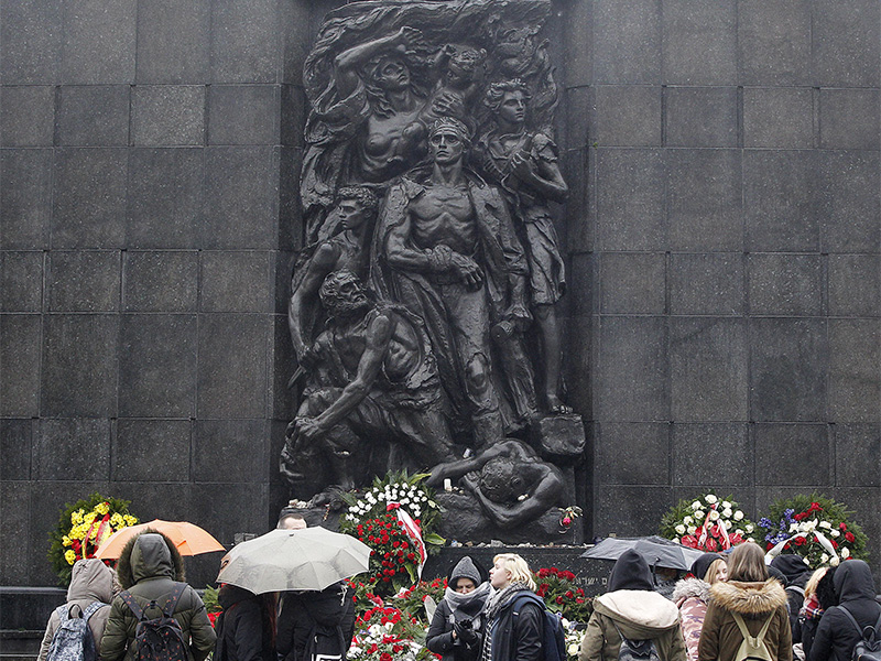 Tourists gather in front of the monument to the Heroes of the Warsaw Ghetto who fought in the 1943 uprising, in Warsaw, Poland, on Feb. 1, 2018. Poland's Senate has backed legislation regulating Holocaust speech, a move that has the potential to strain relations with both Israel and the United States. (AP Photo/Czarek Sokolowski; cutline amended by RNS)