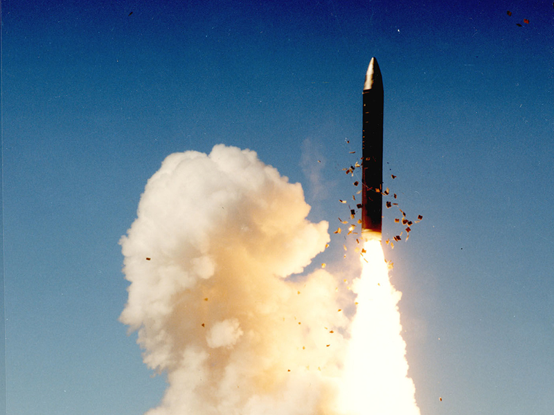 An LGM-118A Peacekeeper missile test launch at Vandenberg Air Force Base in California in 1989. The first-stage solid rocket ignites as the missile clears the silo. Photo by U.S. Air Force via Creative Commons