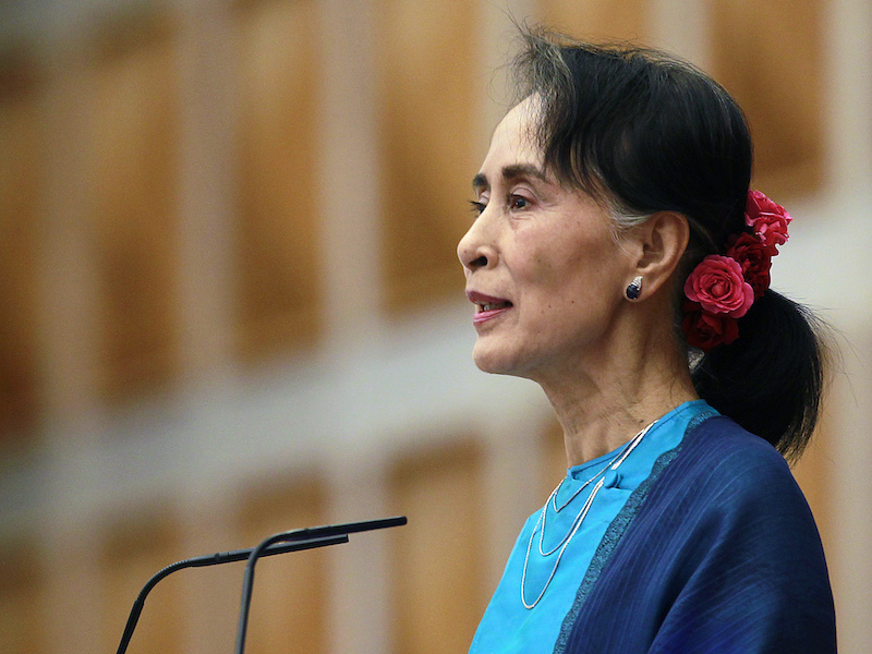 Myanmar's State Counsellor Aung San Suu Kyi smiles as she delivers a speech during a ceremony to mark the 2nd year anniversary of the parliament  in Naypyitaw, Myanmar, Thursday, Feb. 1, 2018. Her speech becomes first one after her National League for Democracy took office in 2016. (AP Photo/Aung Shine Oo)