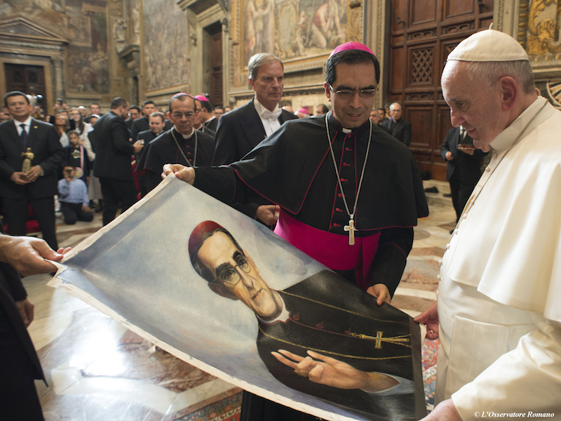 In this Oct. 30, 2015, file photo, Pope Francis is presented with an image of Roman Catholic Archbishop Oscar Romero during a private audience granted to participants in the pilgrimage from El Salvador at the Vatican. Pope Francis has cleared the way for Romero to be made a saint, declaring that a churchman who stood up for the poorest of the poor in the face of right-wing oppression should be a model for Catholics today. (L'Osservatore Romano/Pool Photo via AP)