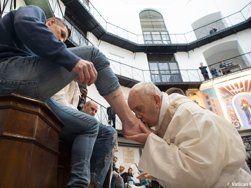 Pope Francis washes the feet of inmates on March 29, 2018, during his visit to the Regina Coeli detention center in Rome, where he celebrated the "Missa in Coena Domini." Francis' visit to a prison on Holy Thursday to wash the feet of some inmates stresses in a pre-Easter ritual that a pope must serve society's marginalized and give them hope. (Vatican Media via AP)