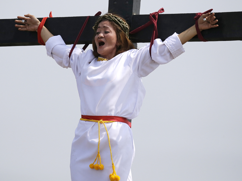 Maryjane Sazon, a 39-year-old beauty salon worker, grimaces as she gets nailed to the cross as part of Good Friday rituals in the village of San Pedro Cutud, Pampanga province, northern Philippines, on March 30, 2018. Sazon said she has joined the tradition for seven years in the hope of being cured of severe headache and nervous breakdown. Thousands of Filipino Roman Catholic devotees and tourists descended Friday on a farming village north of Manila to witness the crucifixion of several men in a re-enactment of Jesus Christ's sufferings, a gory annual tradition church leaders frown upon. (AP Photo/Aaron Favila)