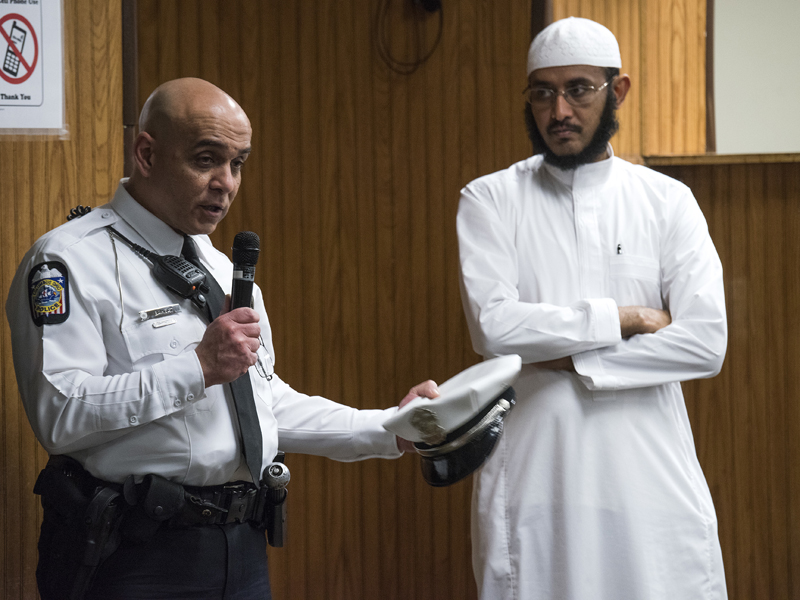 In this Feb. 23, 2018, New American Diversity and Inclusion Officer Khaled Bahgat, with the Columbus Police Department, speaks to members at the Masjid Ibnu Taymiyah Islamic Center after Friday prayer in Columbus, Ohio. Bahgat has been tapped in Ohio's capital to bridge gaps between police and the city's growing immigrant population. (AP Photo/Ty Wright)