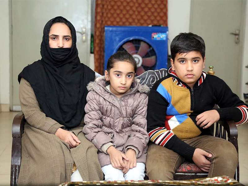Ruby Tabbasum, left, the wife of an Ahmadi man who was killed in a hate crime in 2016, with her daughter Huzaifa Ahmad, 9, and son Amtul Mateen, 12, at their home in Rabwah, Pakistan. RNS photo by Naila Inayat