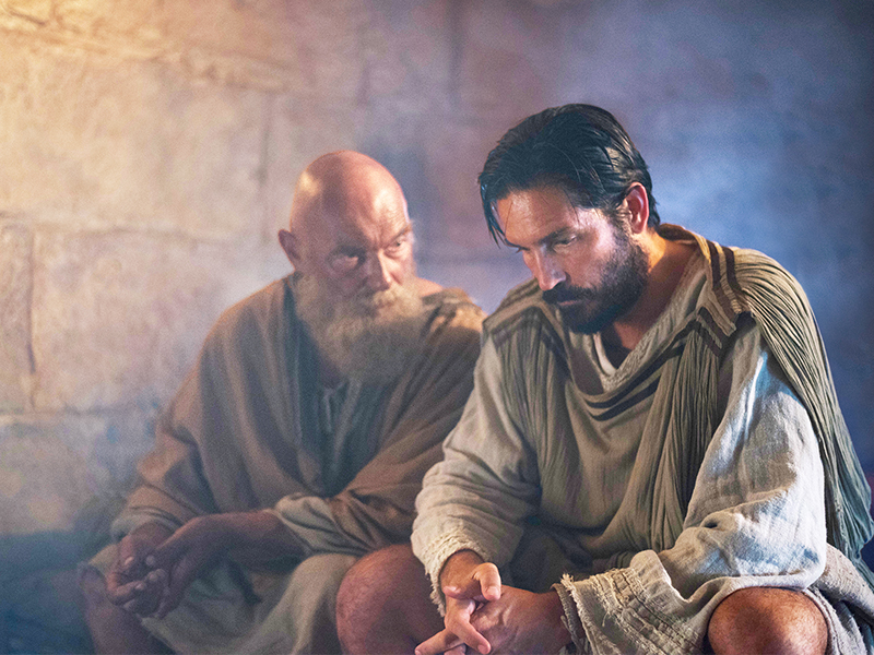 Paul (James Faulkner), left, reminds Luke (Jim Caviezel) that love is the only way in “Paul, Apostle of Christ.” Photo by Mark Cassar, courtesy of CTMG