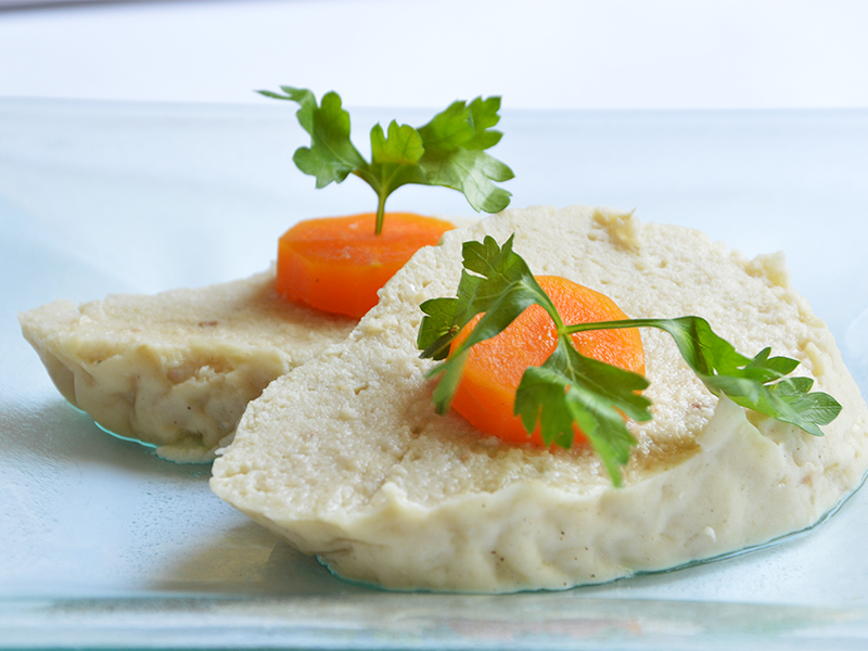 Gefilte fish garnished with carrot slices.  Photo by Mushki Brichta/Creative Commons
