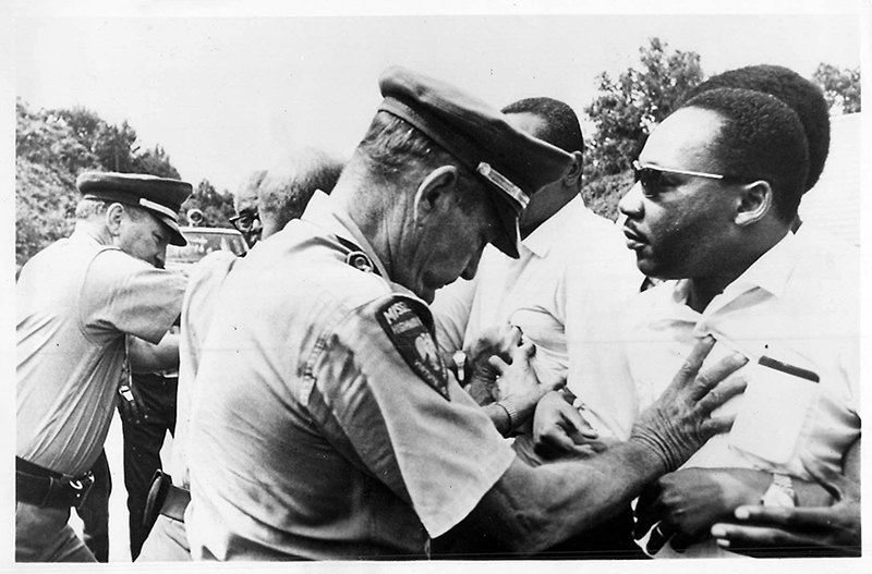 The Rev. Martin Luther King Jr., right, and other civil rights leaders are pushed off the road by police as they resume a 1966 voting rights march begun by James Meredith. Later they continued their walk, marching single file along the highway’s shoulder. Meredith was shot by a white man as he was marching from Memphis, Tenn., to Jackson, capital of Mississippi, in an effort to encourage black residents to vote in the state’s primary election. (RNS archive photo)