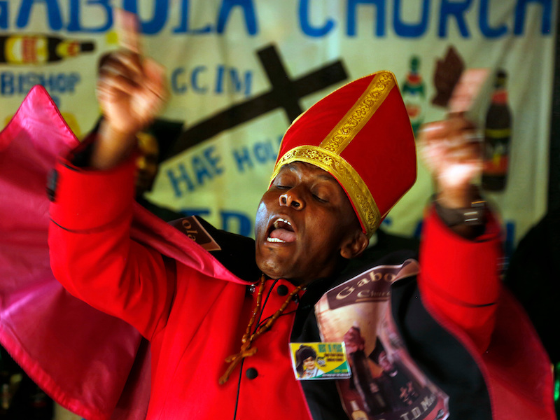 FOR RELEASE SATURDAY, APRIL 2018 AT 09H00GMT. Leader of the Gabola Church, self-proclaimed Pope, Tsietsi Makiti, delivers his sermon during a service in a bar in Orange Farm, south of Johannesburg Sunday, April 15 2018. The new church in South Africa celebrates drinking alcohol and holds enthusiastic, alcohol fuelled services in bars, for those who have been rejected by other churches because they drink alcohol. (AP Photo/Denis Farrell)