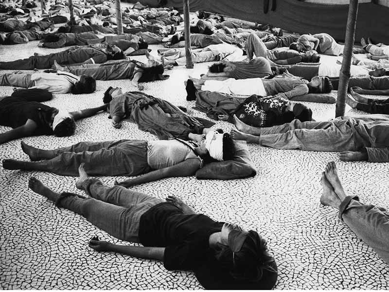In this 1979 image, disciples of Guru Rajneesh Chandra Mohan lie on the ground, in meditation and wearing garments in various shade of orange, at the mystic's cult headquarters in Poona, India. In this setting, Rajneesh offers encounter groups that  