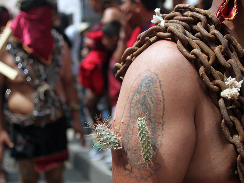 Cacti surround a participant’s tattoo of the Virgin of Guadalupe during the Good Friday procession of the ‘Engrillados’ in Atlixco, Mexico.  RNS photo by Irving Cabrera Torres