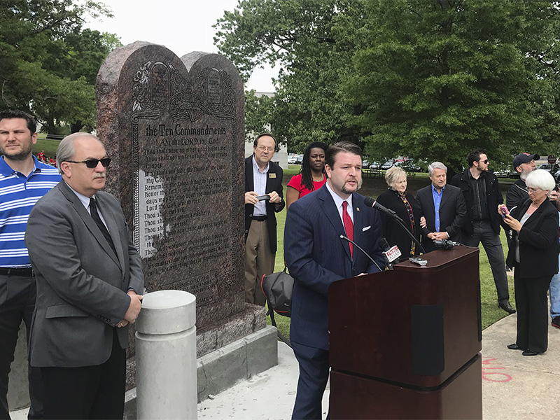 Arkansas Republican state Sen. Jason Rapert speaks at the unveiling of a Ten Commandments monument outside the Arkansas state Capitol in Little Rock on April 26, 2018. The display replaces a monument that was destroyed nearly a year ago. Rapert sponsored the legislation requiring the privately funded monument on state Capitol grounds. (AP Photo/Andrew DeMillo)