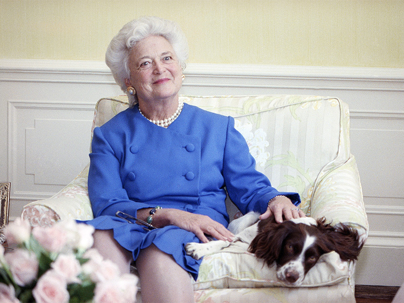 First lady Barbara Bush poses with her dog Millie in 1990. (AP Photo/Doug Mills)