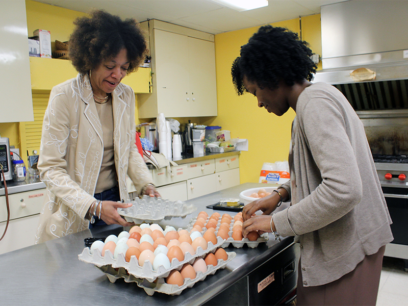 Pleasant Hope Baptist Church executive assistant Tanya Snow, left, and member Sha'von Terrell organize fresh eggs to distribute to church members on April 15, 2018, in Baltimore. RNS photo by Adelle M. Banks