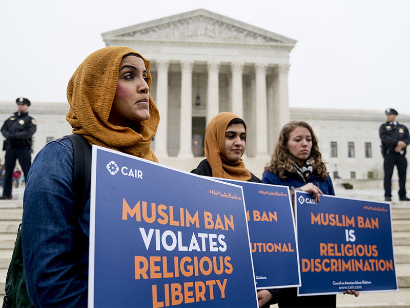 Zainab Chaudry, from left, Zainab Arain and Megan Fair with the Council on American-Islamic Relations stand outside the Supreme Court for an anti-Muslim ban rally as the court hears arguments about whether President Trump's ban on travelers from several mostly Muslim countries violates immigration law or the Constitution, on April 25, 2018, in Washington. (AP Photo/Andrew Harnik)
