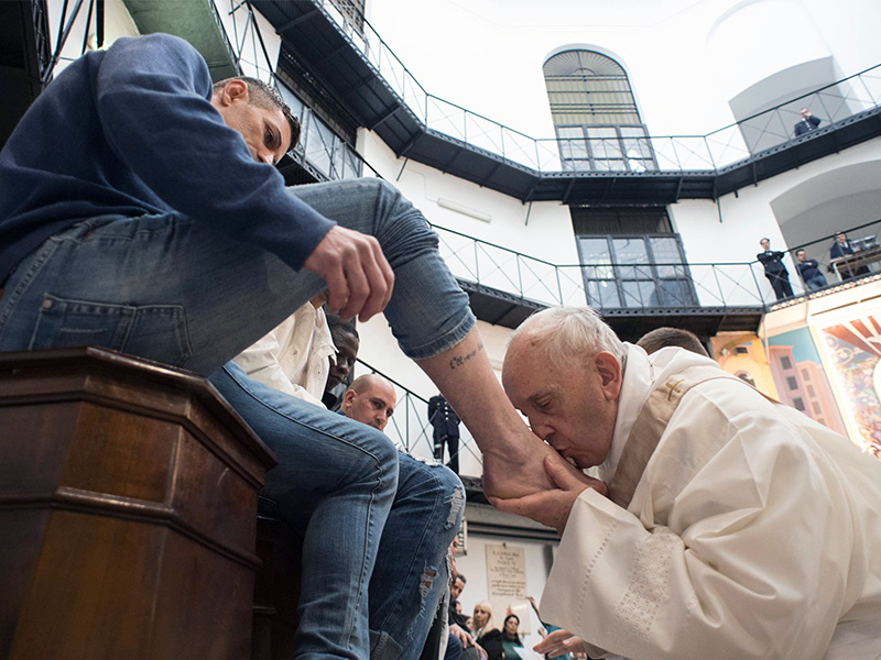 Pope Francis washes the feet of inmates on March 29, 2018, during his visit to the Regina Coeli detention center in Rome, where he celebrated the 