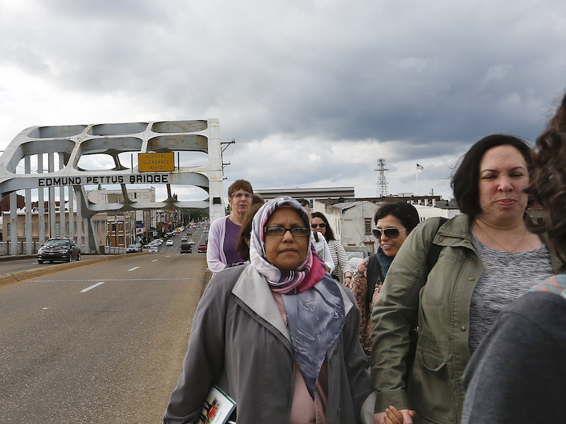 Shared Hosein, left, of Boston, with the Sisterhood of Salaam Shalom group as its members walk across the Edmund Pettus Bridge on April 24, 2018, in Selma, Ala. (AP Photo/Brynn Anderson)