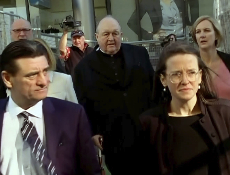 In this image made from video, Archbishop Philip Wilson, center, heads to Newcastle Local Court, north of Sydney, Australia Tuesday, May 22, 2018. The Australian archbishop who was the most senior Roman Catholic cleric in the world charged with covering up child sex abuse was convicted Tuesday. (Australian Broadcasting Corporation via AP)