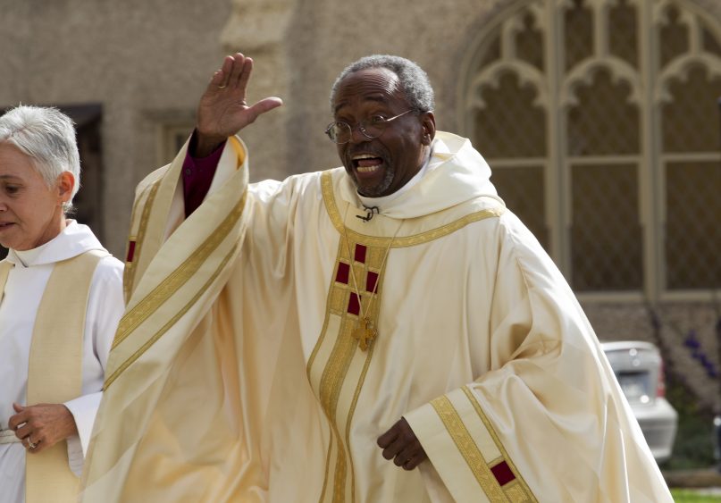 Episcopal Church Presiding Bishop-elect Michael Curry gives waves to the crowd as he arrives at the Washington National Cathedral, Sunday, Nov. 1, 2015, in Washington. Curry, who comes to the job after nearly 15 years leading the Diocese of North Carolina, was elected last summer to succeed Presiding Bishop Katharine Jefferts Schori, the first woman leader of the church. (AP Photo/Jose Luis Magana)