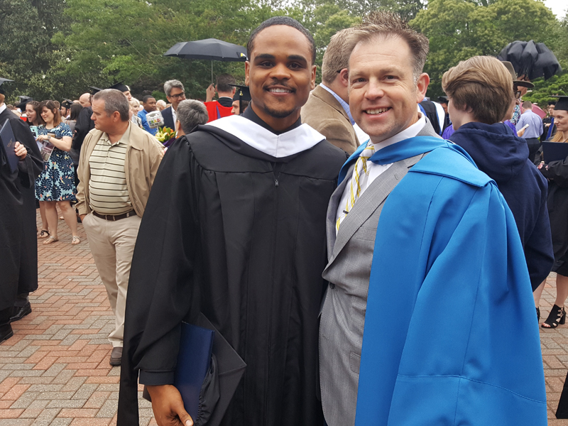 Sean Robinson, left, stands next to professor Stephen Eccher at the commencement ceremony at Southeastern Baptist Theological Seminary in May 2017. Robinson graduated May 11, 2018, with another master's degree. Photo courtesy Sean Robinson