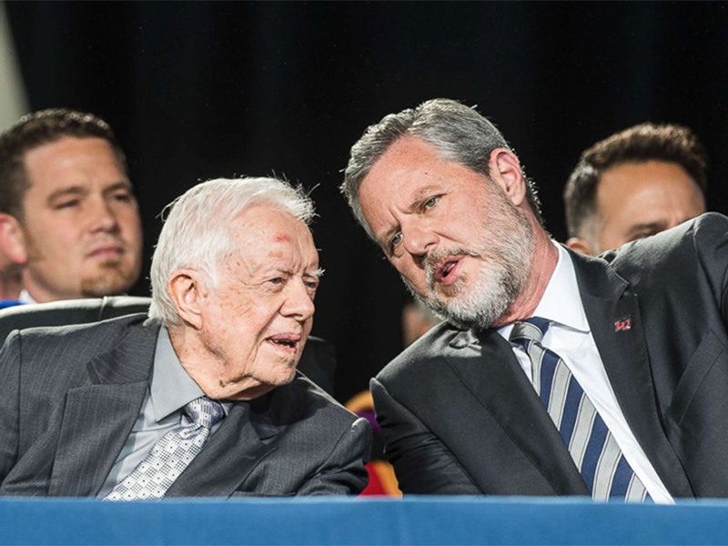 Former President Jimmy Carter, left, talks with Liberty University president Jerry Falwell Jr. during the 45th commencement ceremony at Liberty on May 19, 2018, in Lynchburg, Va. (Lathan Goumas/The News & Advance via AP)