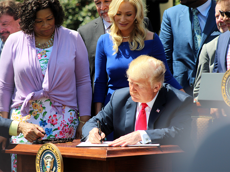President Trump signs the White House Faith and Opportunity Initiative executive order during a National Day of Prayer event in the Rose Garden of the White House on May 3, 2018, in Washington. RNS photo by Adelle M. Banks