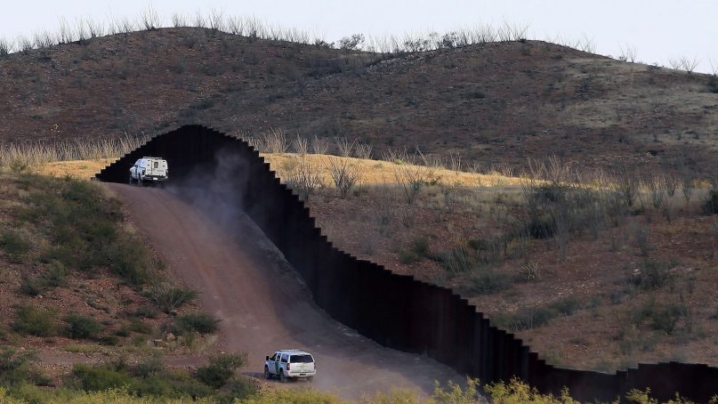 This Oct. 2, 2012, file photo shows U.S. Border Patrol agents patrolling the border fence near Naco, Arizona. (AP Photo/Ross D. Franklin, File)