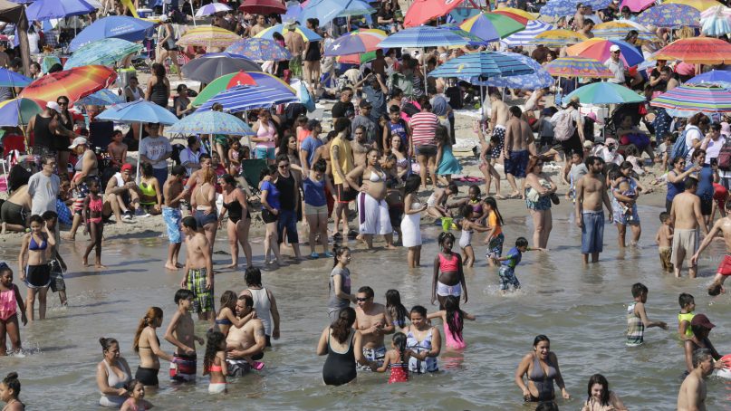 Thousands gather on Coney Island Beach before Fourth of July fireworks on July 4, 2017, in New York. (AP Photo/Bebeto Matthews)