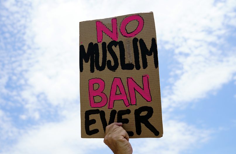 A protester holds up a sign that reads 