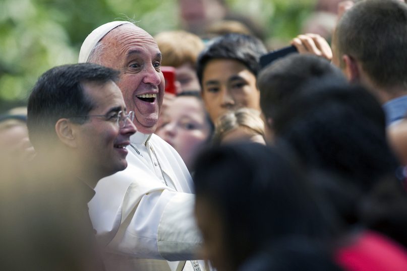 Pope Francis laughs while greeting school children after he arrived at the Apostolic Nunciature, the Vatican's diplomatic mission in Washington, on Sept. 24, 2015, after his address to a joint meeting of Congress on Capitol Hill.  (AP Photo/Cliff Owen)