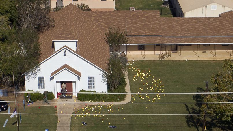 Flags mark evidence on the lawn of the First Baptist Church in Sutherland Springs, Texas, Monday, Nov. 6, 2017, a day after over 20 people died in a mass shooting Sunday. (Jay Janner/Austin American-Statesman via AP)