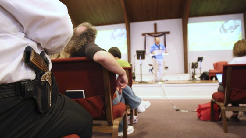 Cliff Meadows wears his firearm as he listens to pastor Ken Pagano during a service at the New Bethel Church where people were invited to bring their own firearms to the sanctuary in Louisville, Ky., Saturday, June 27, 2009. (AP Photo/Ed Reinke, Pool)